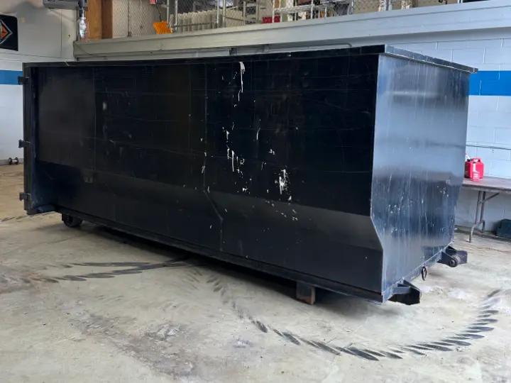 Ready 2 Roll 21-yard dumpster used for junk removal, side view